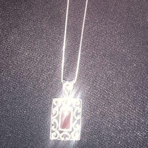 A 16 in sterling silver necklace with a sterling silver charm